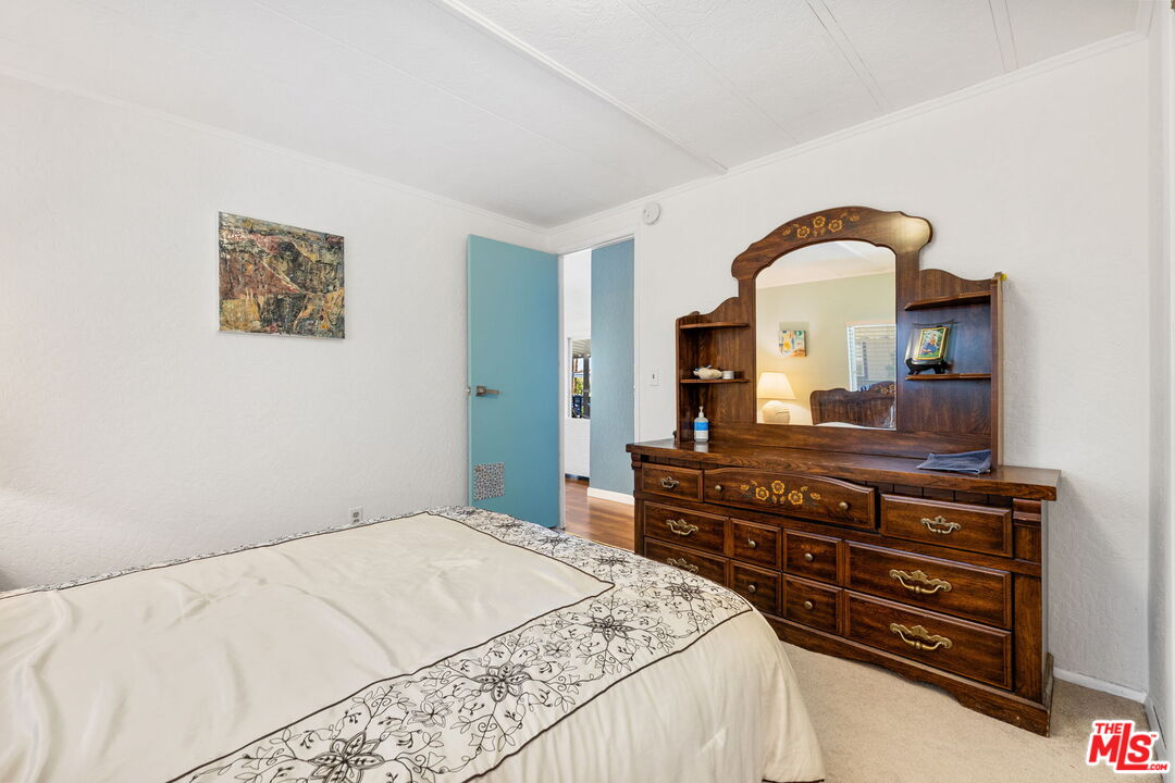 74711 Dillon Road, Unit 503 Desert Hot Springs, CA 92241 - Photo 38 of 52 a bedroom with a bed and a dresser