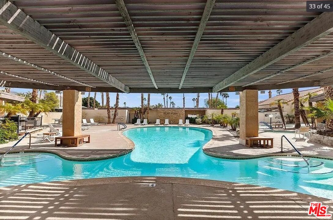74711 Dillon Road, Unit 503 Desert Hot Springs, CA 92241 - Photo 39 of 52 a view of a swimming pool with outdoor seating