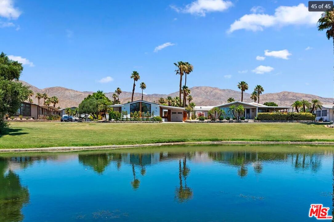 74711 Dillon Road, Unit 503 Desert Hot Springs, CA 92241 - Photo 45 of 52 a view of a lake with a house in the background