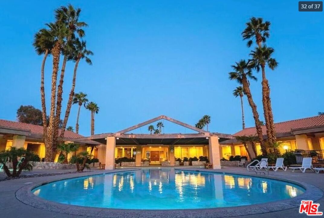74711 Dillon Road, Unit 503 Desert Hot Springs, CA 92241 - Photo 46 of 52 a view of a swimming pool with a table and chairs