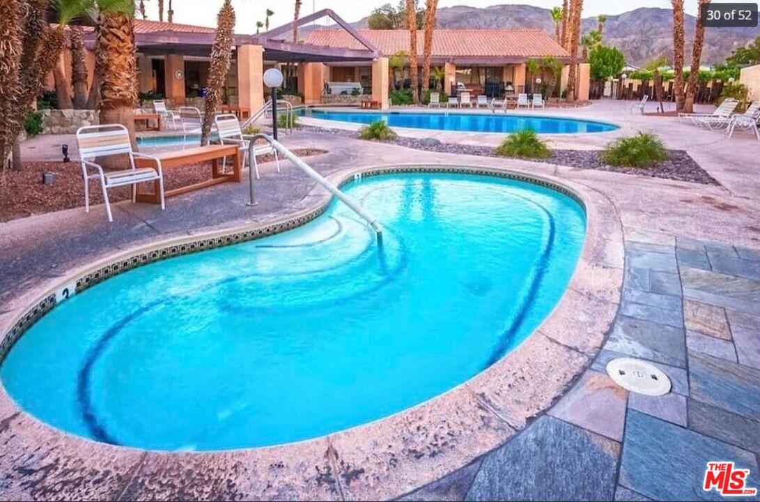 74711 Dillon Road, Unit 503 Desert Hot Springs, CA 92241 - Photo 47 of 52 a view of a swimming pool with a lounge chairs