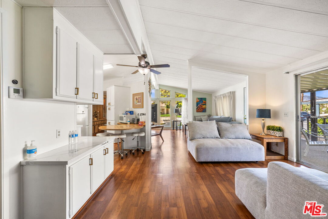 74711 Dillon Road, Unit 503 Desert Hot Springs, CA 92241 - Photo 6 of 52 a large living room with stainless steel appliances furniture a rug and a view of kitchen