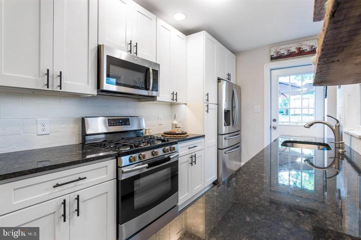 419 North Olive Street Media, PA 19063 - Photo 11 of 31 a kitchen with stainless steel appliances granite countertop a stove a refrigerator and a microwave