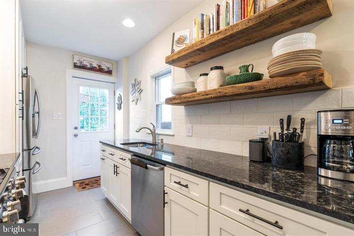 419 North Olive Street Media, PA 19063 - Photo 12 of 31 a kitchen with stainless steel appliances granite countertop a sink and cabinets