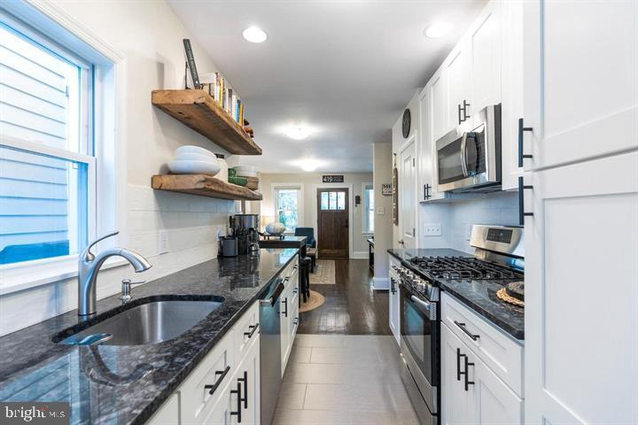 419 North Olive Street Media, PA 19063 - Photo 14 of 31 a kitchen with stainless steel appliances granite countertop a sink stove and cabinets
