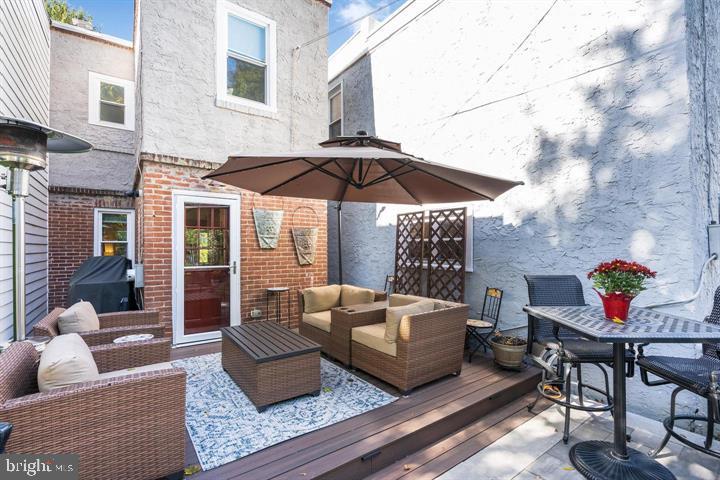 419 North Olive Street Media, PA 19063 - Photo 17 of 31 a view of a patio with couches table and chairs under an umbrella