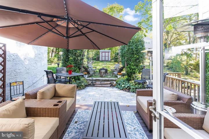 419 North Olive Street Media, PA 19063 - Photo 18 of 31 a patio with wooden floor a yard a table and chairs