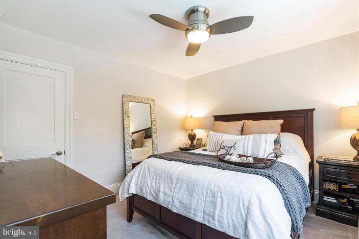 419 North Olive Street Media, PA 19063 - Photo 23 of 31 a bedroom with a bed ceiling fan and a wooden floor