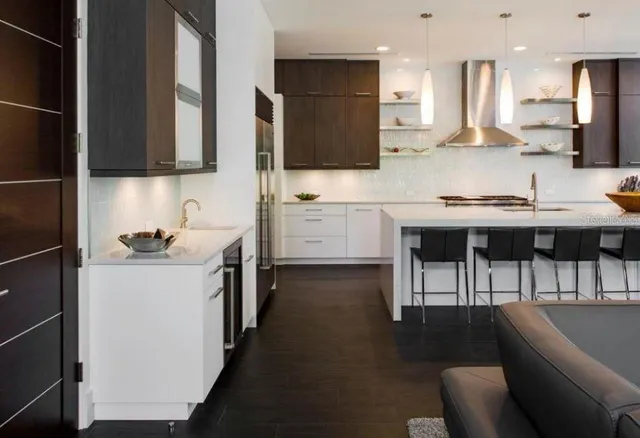 a kitchen with stainless steel appliances kitchen island granite countertop a sink and cabinets