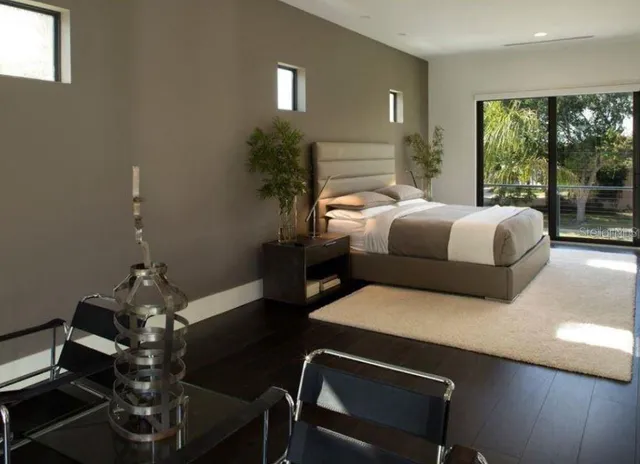 a bedroom with a bed and a potted plant