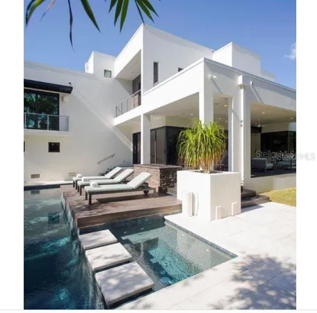 a swimming pool with outdoor seating and yard
