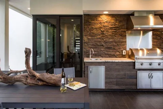 a kitchen with a sink and a wooden floor