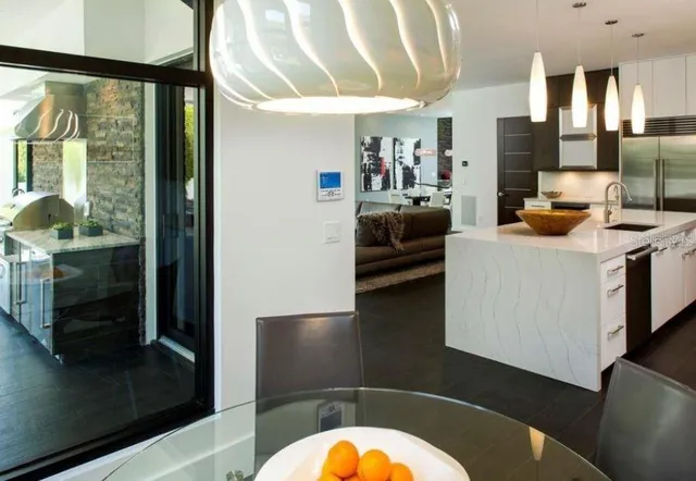 a living room with a large window wooden floor and furniture
