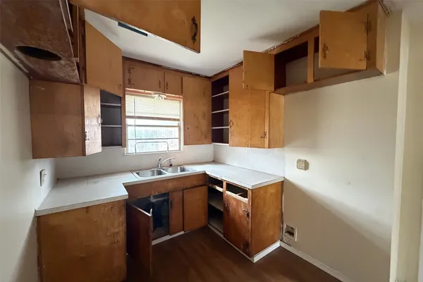 a room with a sink cabinets and window