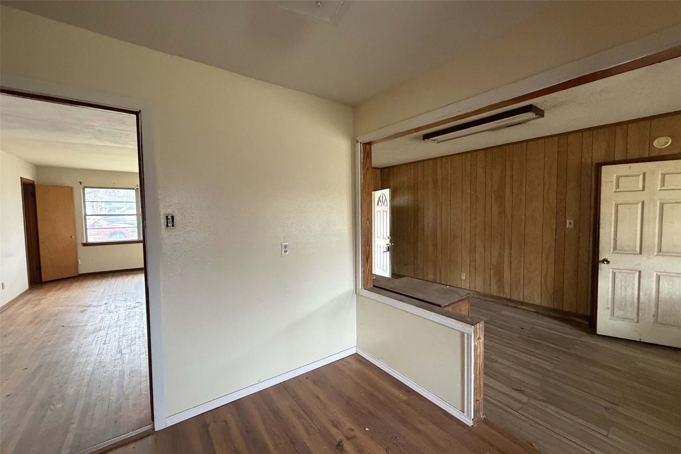 3207 Washington Street Pasadena, TX 77503 - Photo 4 of 9 a view of an empty room with wooden floor and a window