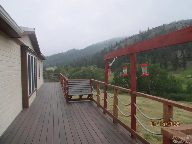 a view of balcony with wooden floor and bench