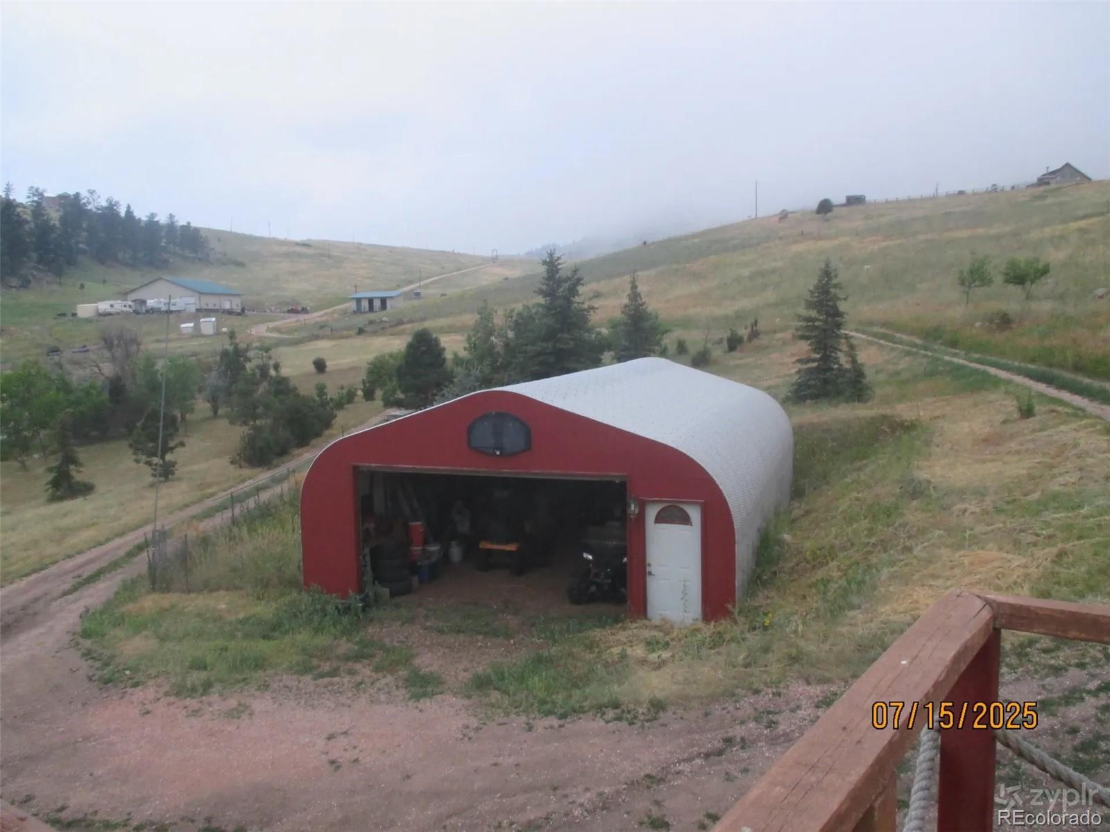 15 Sloan Road Livermore, CO 80536 - Photo 24 of 27 a view of a yard with an outdoor space and deck