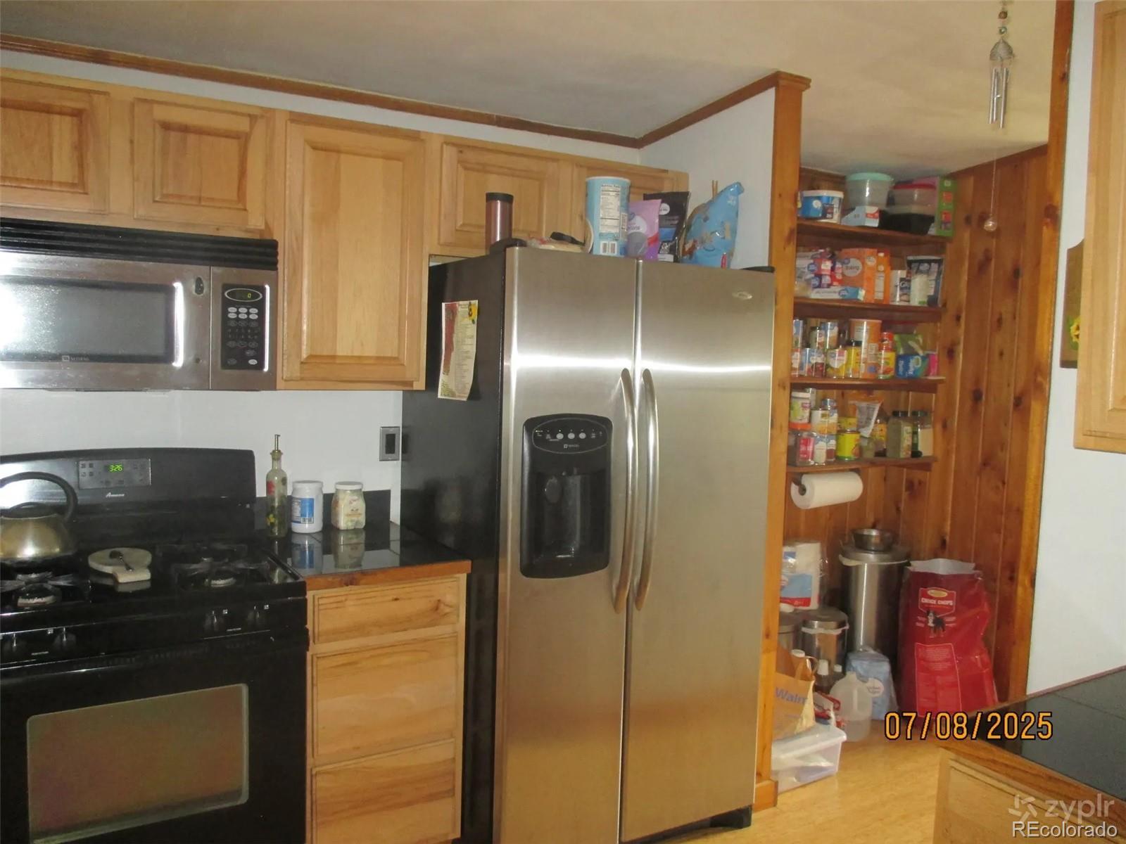 15 Sloan Road Livermore, CO 80536 - Photo 4 of 27 a kitchen with stainless steel appliances granite countertop a refrigerator and a stove