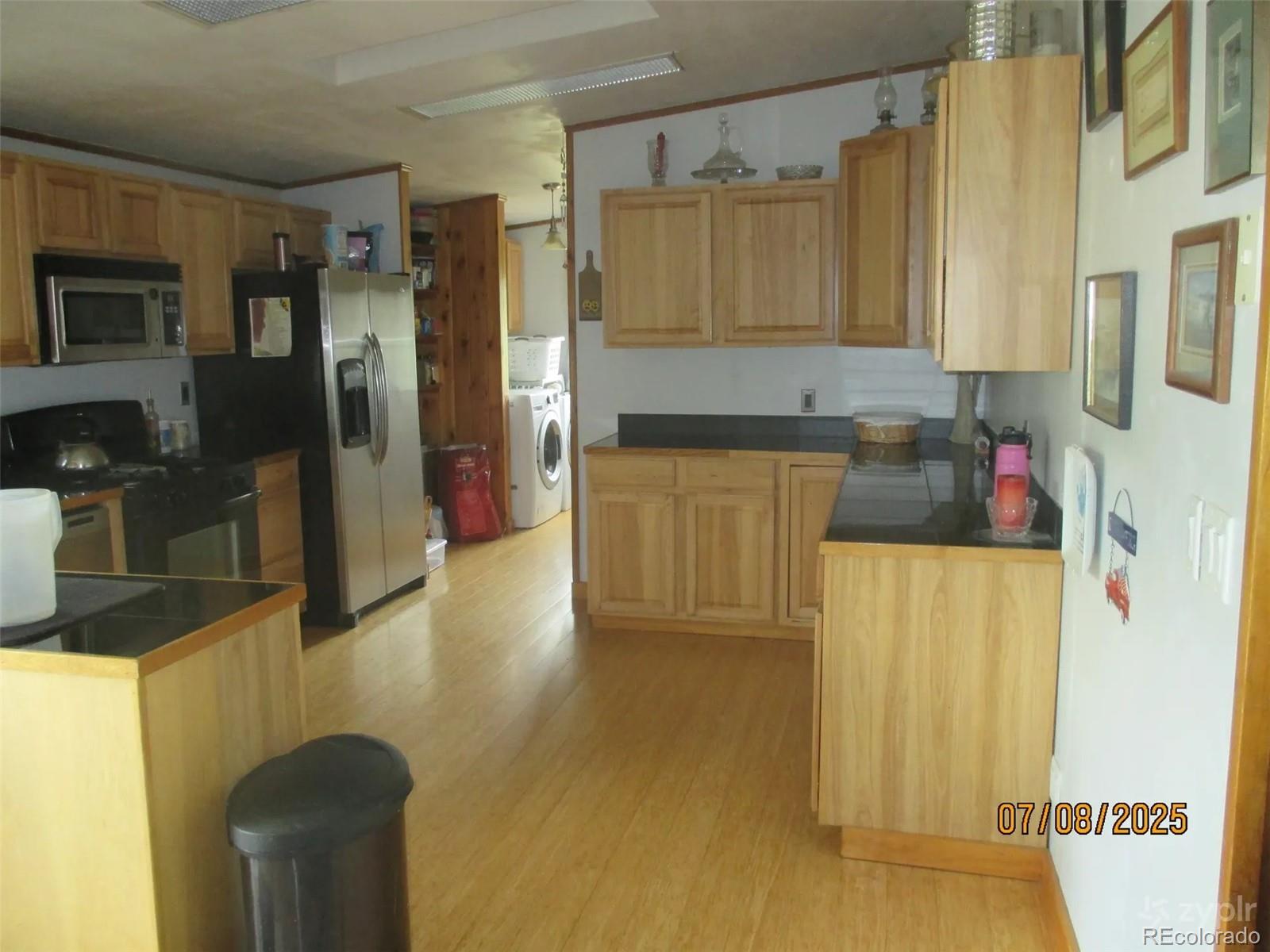 15 Sloan Road Livermore, CO 80536 - Photo 5 of 27 a kitchen with a refrigerator and a stove