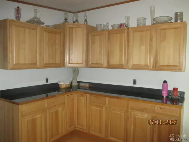 a kitchen with granite countertop a sink and cabinets