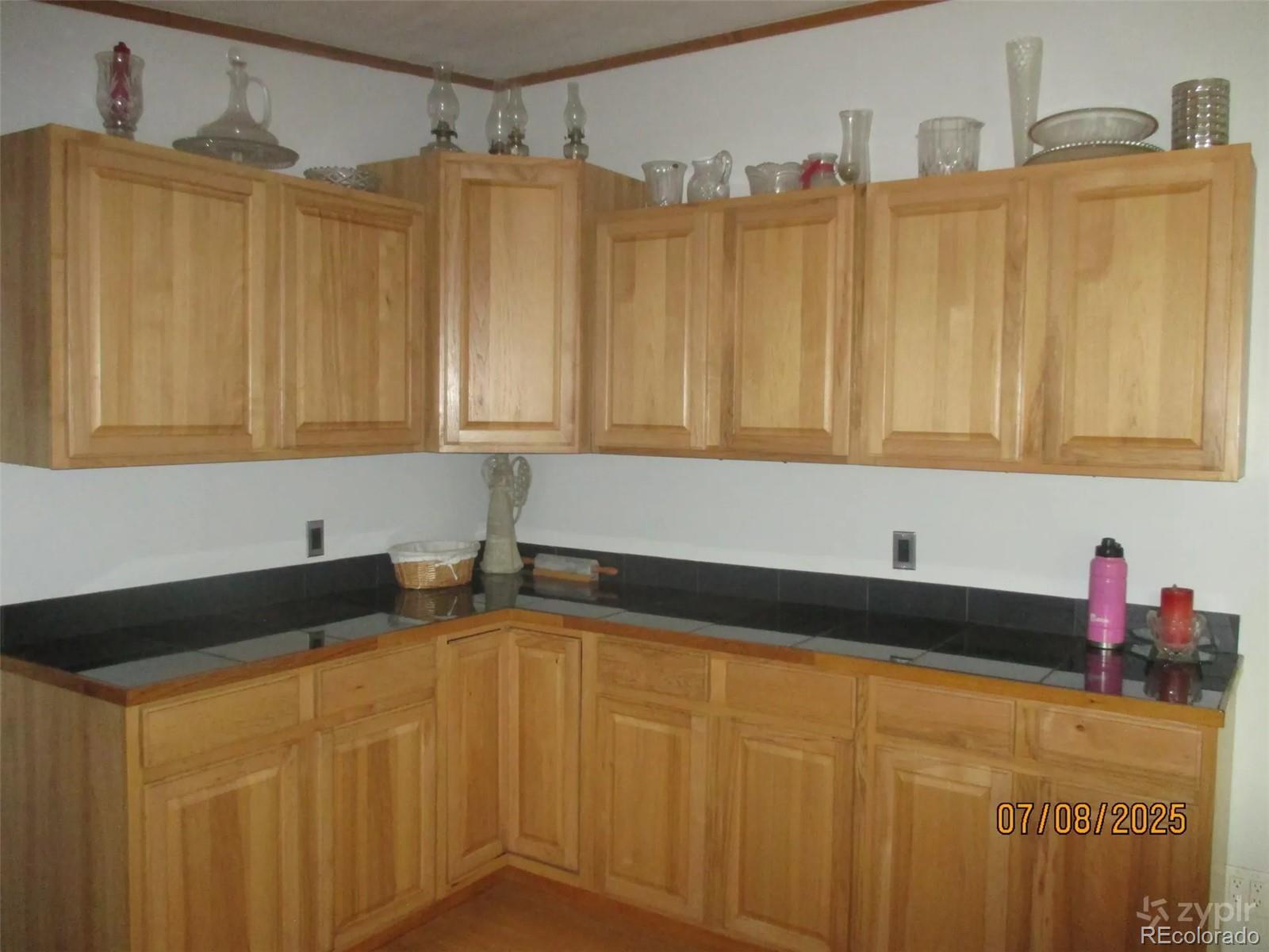 15 Sloan Road Livermore, CO 80536 - Photo 6 of 27 a kitchen with granite countertop a sink and cabinets