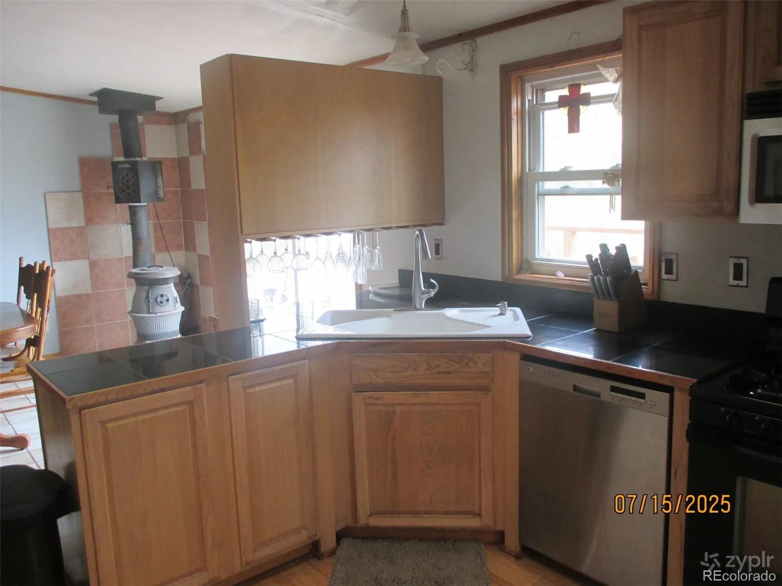 15 Sloan Road Livermore, CO 80536 - Photo 7 of 27 a kitchen with cabinets and window