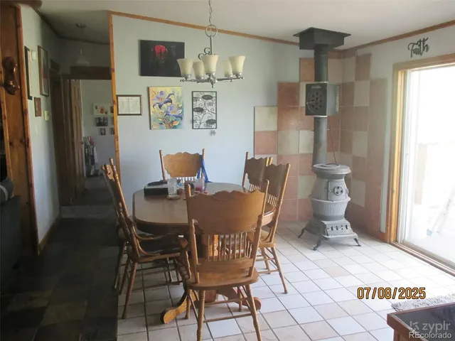 a view of a dining room with furniture a chandelier and wooden floor
