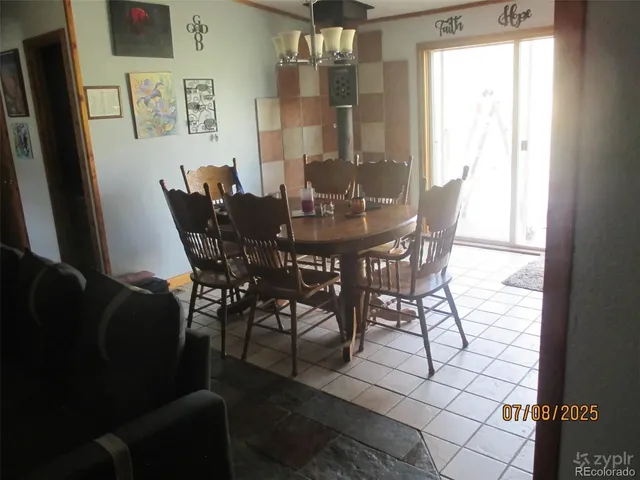 a view of a dining room with furniture and chandelier