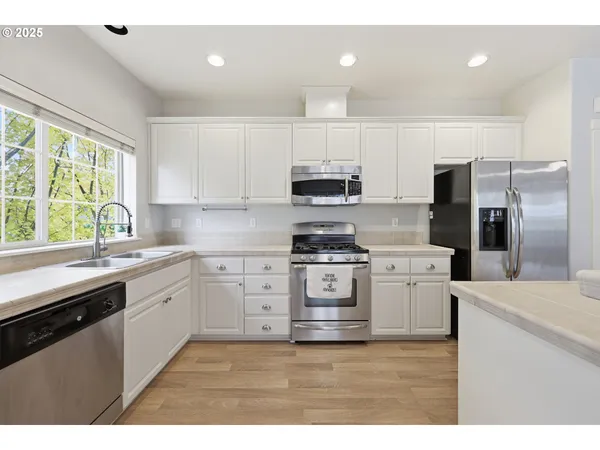 a kitchen with a stove a sink and a refrigerator