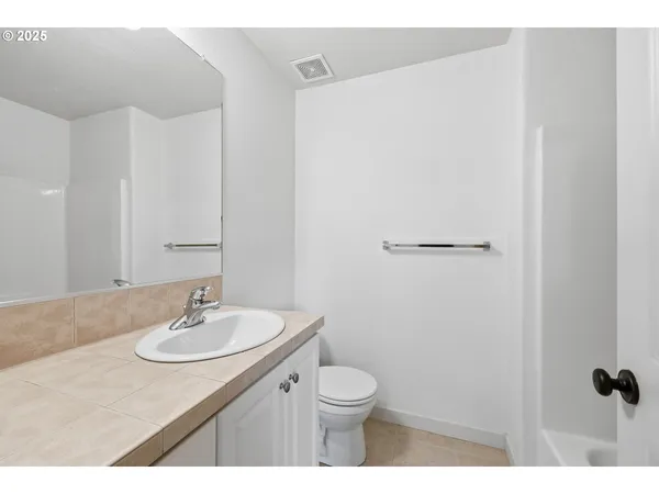 a bedroom with a bed a couch and a window