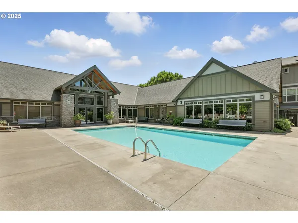 a view of house with outdoor space and swimming pool