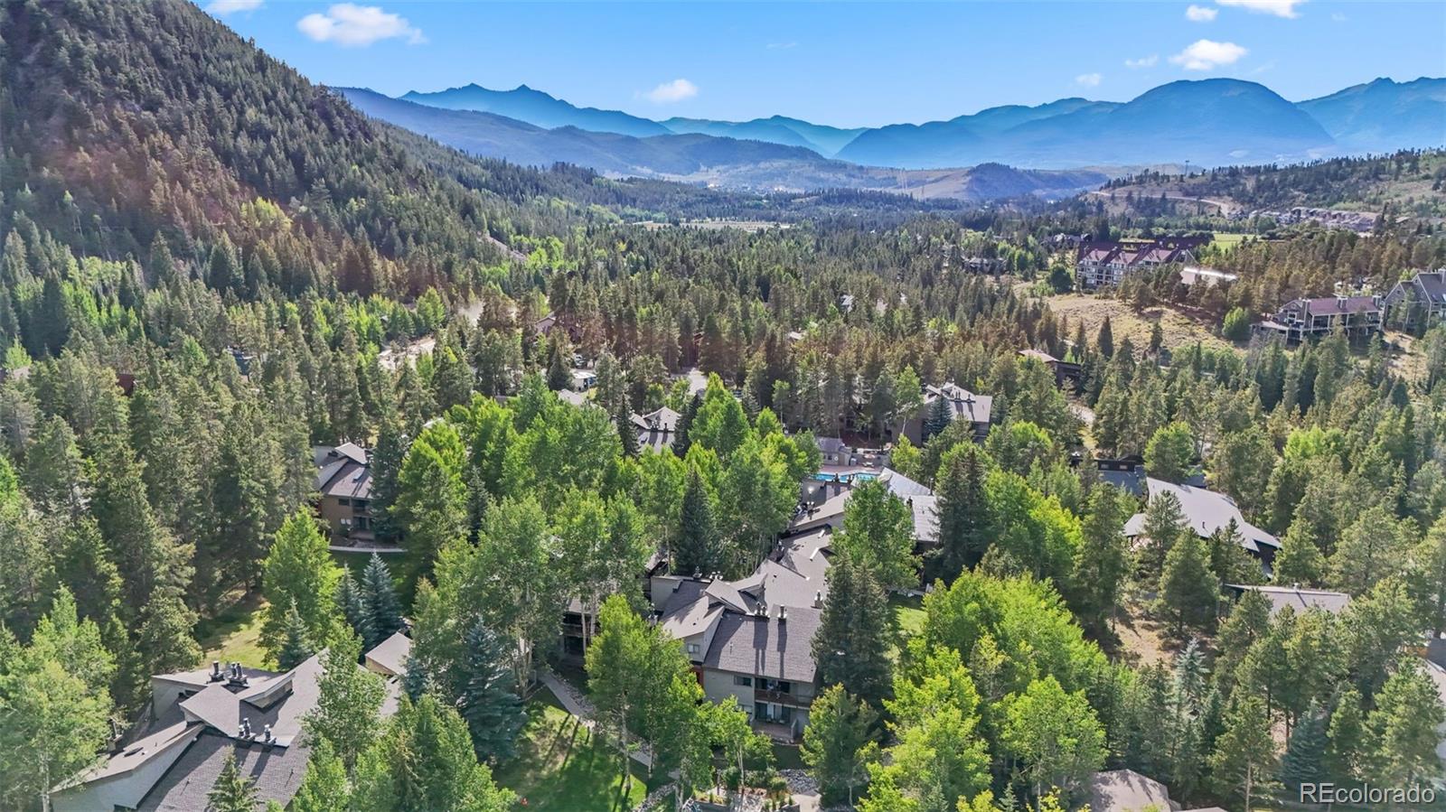 1977 Soda Ridge Road, Unit 1180 Dillon, CO 80435 - Photo 1 of 24 a view of a lush green hillside and a building