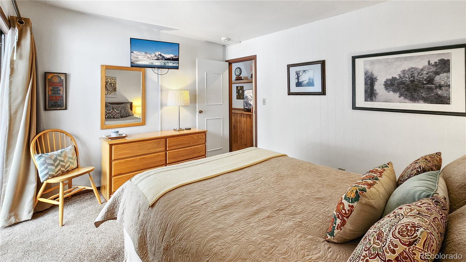 1977 Soda Ridge Road, Unit 1180 Dillon, CO 80435 - Photo 11 of 24 a bedroom with a bed and wooden floor