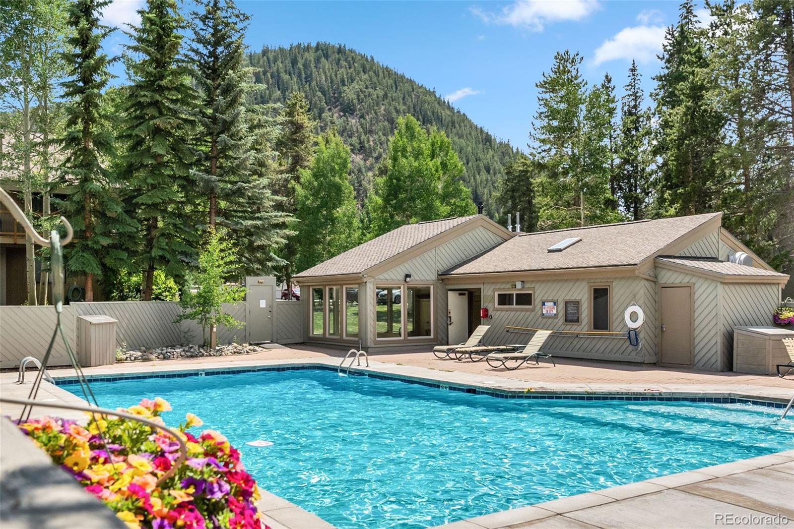1977 Soda Ridge Road, Unit 1180 Dillon, CO 80435 - Photo 19 of 24 a front view of a house with garden and swimming pool