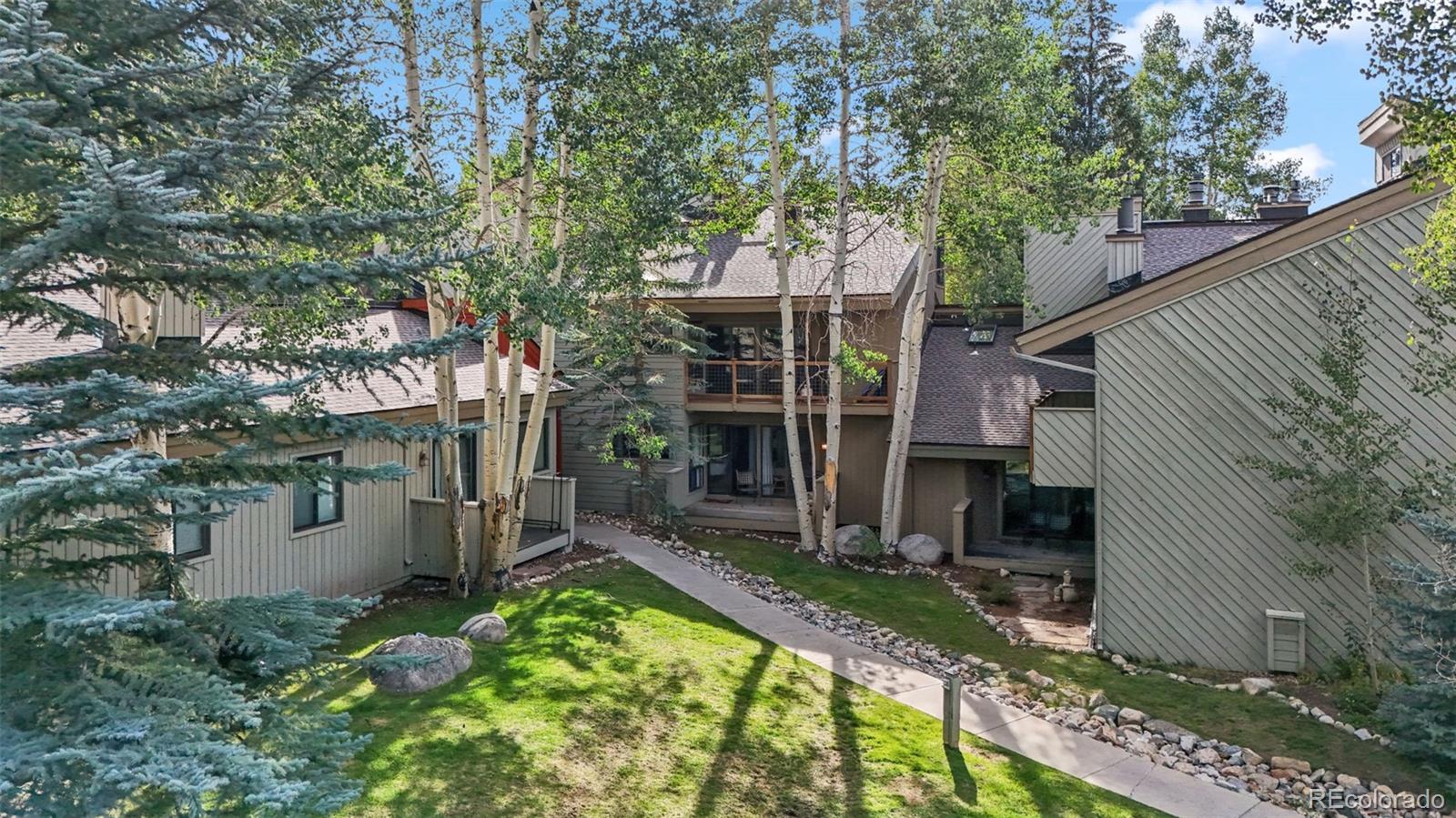1977 Soda Ridge Road, Unit 1180 Dillon, CO 80435 - Photo 2 of 24 aerial view of a house with a yard and large tree