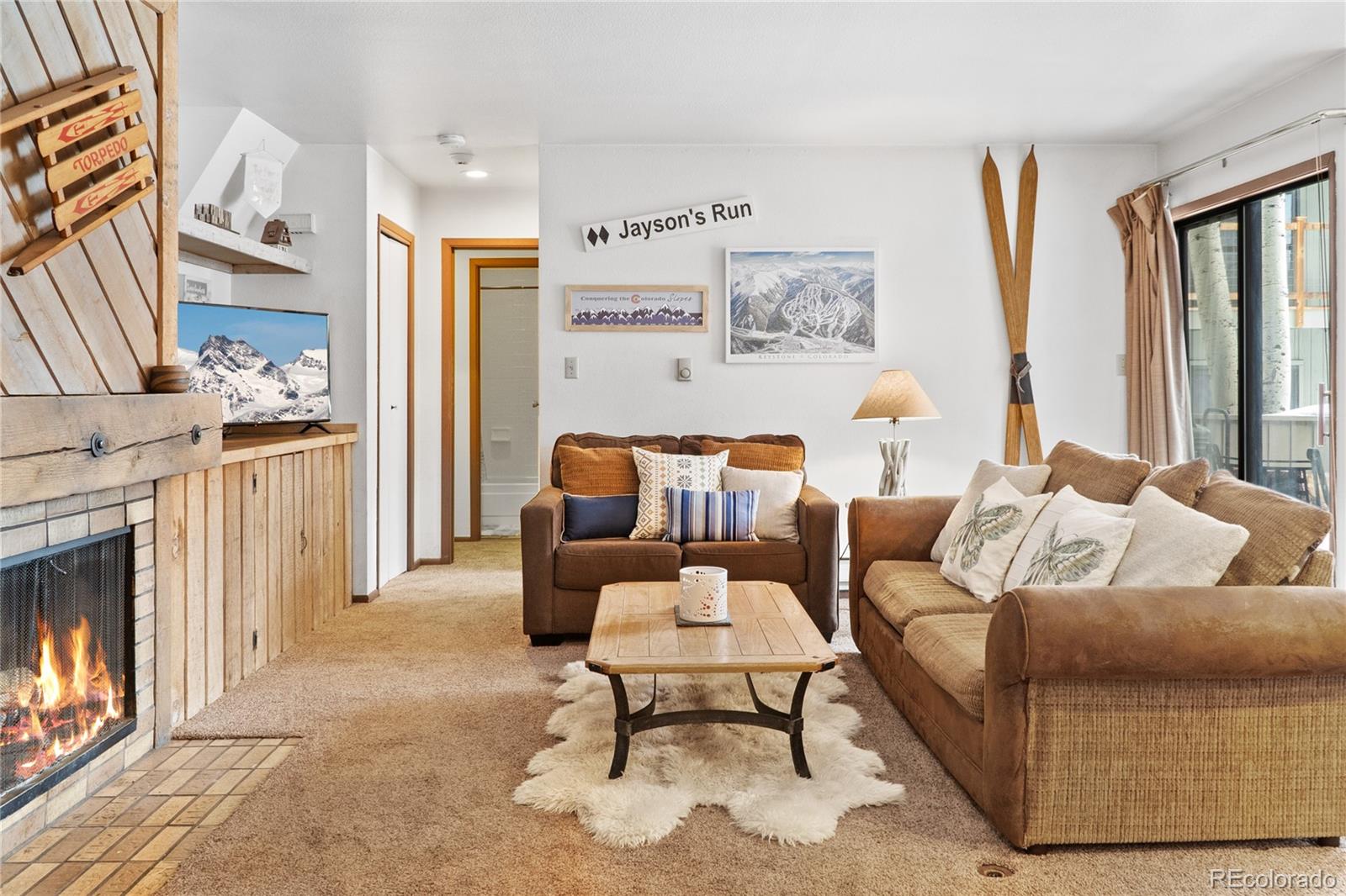 1977 Soda Ridge Road, Unit 1180 Dillon, CO 80435 - Photo 3 of 24 a living room with furniture and a fireplace