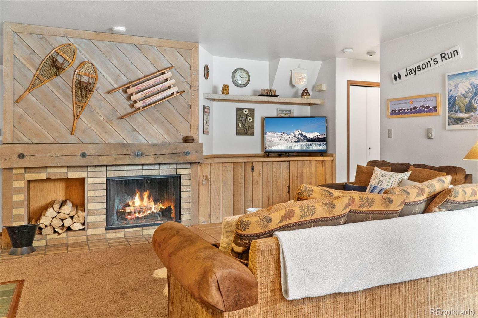 1977 Soda Ridge Road, Unit 1180 Dillon, CO 80435 - Photo 6 of 24 a living room with furniture and a fireplace