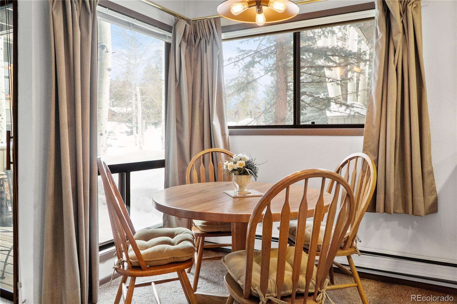 1977 Soda Ridge Road, Unit 1180 Dillon, CO 80435 - Photo 9 of 24 a view of a dining room with furniture window and outside view