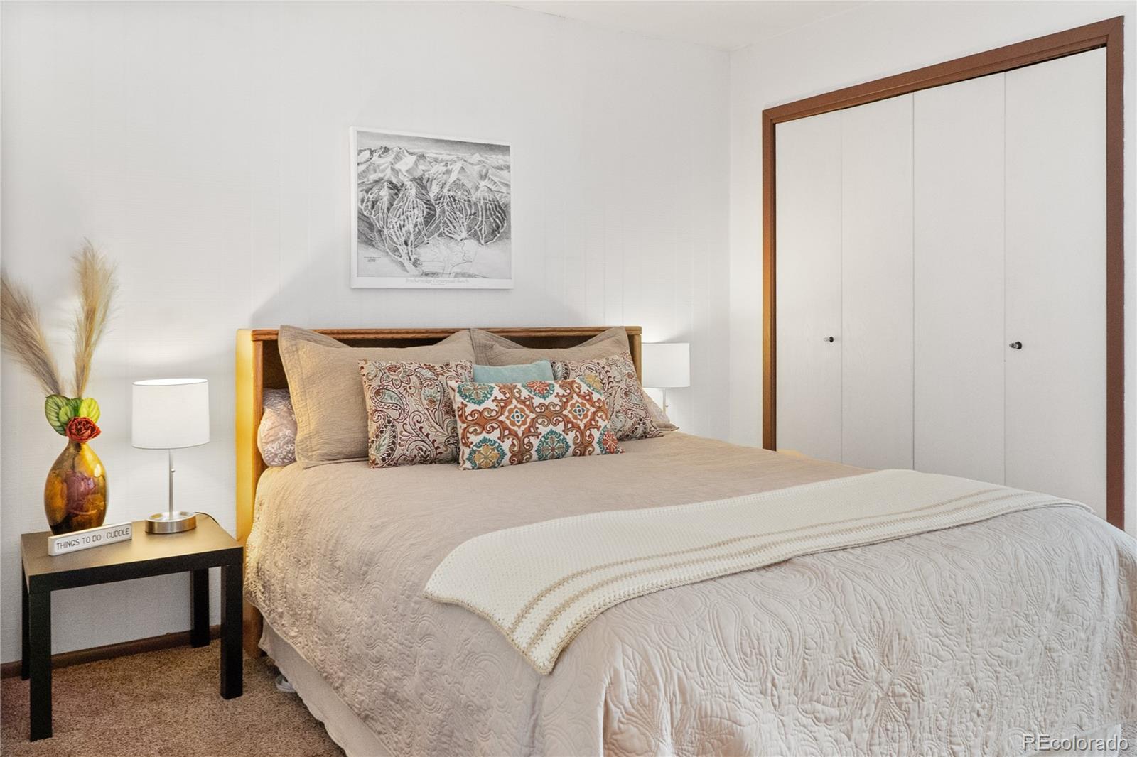 1977 Soda Ridge Road, Unit 1180 Dillon, CO 80435 - Photo 10 of 24 a bedroom with a bed and a painting on the wall