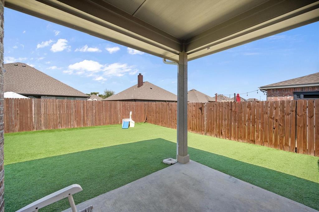 909 Avagail Avenue Springtown, TX 76082 - Photo 24 of 26 a view of a backyard with a slide