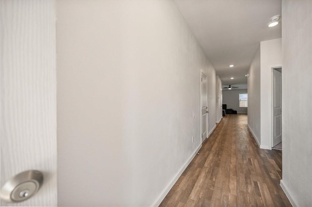 909 Avagail Avenue Springtown, TX 76082 - Photo 4 of 26 a view of a hallway with wooden floor