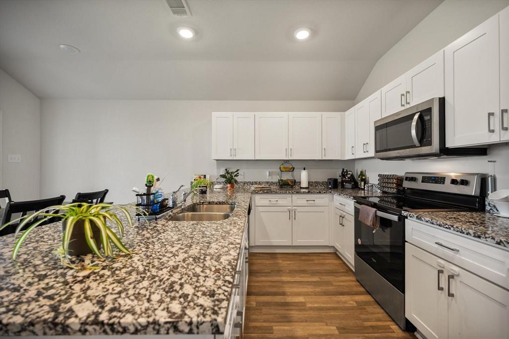 909 Avagail Avenue Springtown, TX 76082 - Photo 8 of 26 a kitchen with appliances a sink and cabinets