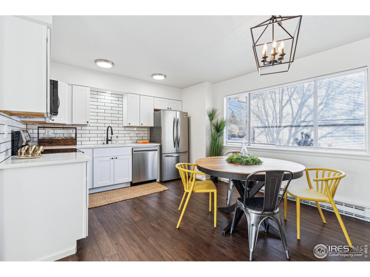 2408 Orchard Place Fort Collins, CO 80521 - Photo 3 of 10 a kitchen with a dining table chairs and refrigerator