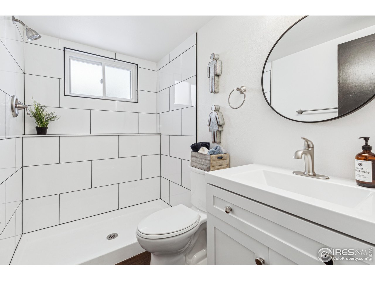 2408 Orchard Place Fort Collins, CO 80521 - Photo 5 of 10 a bathroom with a toilet a sink a mirror and shower
