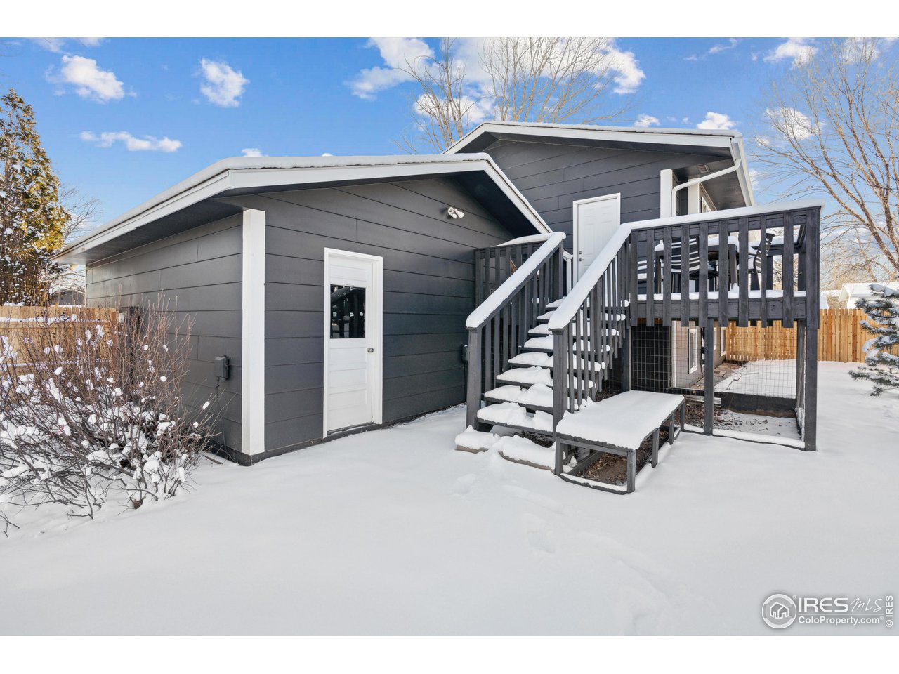2408 Orchard Place Fort Collins, CO 80521 - Photo 9 of 10 a roof deck with table and chairs with wooden fence