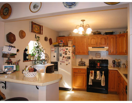 36-ab Monson Road Wales, MA 01081 - Photo 8 of 17 a kitchen with stainless steel appliances a stove a refrigerator a sink and dining table with wooden floor