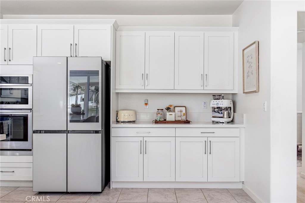 32797 Hayden Road Menifee, CA 92584 - Photo 16 of 51 a kitchen with white cabinets and refrigerator