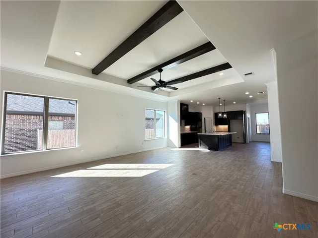 a view of a livingroom with a kitchen and a window