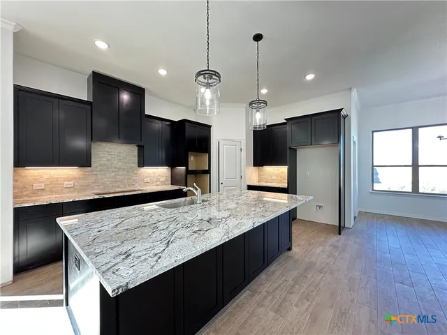 a kitchen with stainless steel appliances kitchen island a large island in the center