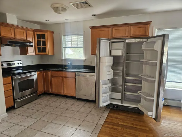 a kitchen with stainless steel appliances a stove and a refrigerator